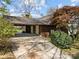 Covered carport with doors and lush landscaping surrounding the rustic home at 126 Balmoral Dr, Mooresville, NC 28117