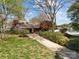 Scenic view of a home with a lakefront, framed by mature trees and landscaping at 126 Balmoral Dr, Mooresville, NC 28117