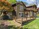 Charming rustic home featuring a wooden deck and mature landscaping, offering a serene outdoor space at 126 Balmoral Dr, Mooresville, NC 28117