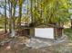 Detached garage nestled amongst mature trees, offering plenty of parking and storage at 126 Balmoral Dr, Mooresville, NC 28117
