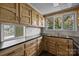 Kitchen with custom cabinets, black countertops, and a window overlooking the lake at 126 Balmoral Dr, Mooresville, NC 28117