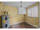 Utility room with water heater, storage cabinets, and vinyl flooring at 126 Balmoral Dr, Mooresville, NC 28117
