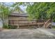 View of the back of the house featuring a two tiered wooden deck and natural siding at 128 Allenton St, Norwood, NC 28128