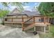 View of the back of the house featuring a two tiered wooden deck and natural siding at 128 Allenton St, Norwood, NC 28128