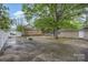 Spacious backyard with a large concrete patio and lush landscaping at 128 Allenton St, Norwood, NC 28128