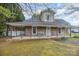 Charming home featuring a covered front porch with detailed supports, offering a cozy and inviting curb appeal at 128 Allenton St, Norwood, NC 28128