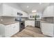 Updated kitchen featuring white cabinets, granite countertops, stainless steel appliances and modern flooring at 128 Allenton St, Norwood, NC 28128