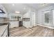 Bright kitchen with stainless steel appliances, granite countertops, and wood look flooring at 128 Allenton St, Norwood, NC 28128