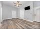 Bright living room featuring stylish laminate flooring, neutral walls, ceiling fan, and wall mounted TV at 128 Allenton St, Norwood, NC 28128
