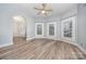 Bright living room with hardwood floors, neutral walls, and an arched doorway enhancing the spacious feel at 128 Allenton St, Norwood, NC 28128