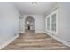 Well-lit living room showcasing neutral paint, hardwood floors, and an arched doorway leading to another room at 128 Allenton St, Norwood, NC 28128