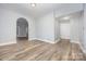 Well-lit living room showcasing neutral paint, hardwood floors, and an arched doorway leading to another room at 128 Allenton St, Norwood, NC 28128
