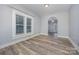 Well-lit living room showcasing neutral paint, hardwood floors, and an arched doorway leading to another room at 128 Allenton St, Norwood, NC 28128