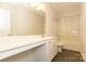 Clean bathroom featuring a modern vanity with dual sink and a shower-tub combination with curtain at 1415 Troon Dr, Salisbury, NC 28144