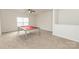 Well-lit bonus room with plush carpeting and billiard table, perfect for recreation and relaxation at 1415 Troon Dr, Salisbury, NC 28144