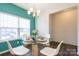 A bright dining room featuring a glass-top table, white chairs, and wood floors at 1415 Troon Dr, Salisbury, NC 28144