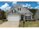 Charming two-story home with a gray exterior, a well-manicured lawn, and a two-car garage at 1415 Troon Dr, Salisbury, NC 28144