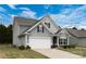 Side view of a charming two-story home with a gray exterior and a two-car garage at 1415 Troon Dr, Salisbury, NC 28144