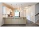 Open kitchen with stainless steel appliances, granite countertops, and white cabinets at 1415 Troon Dr, Salisbury, NC 28144