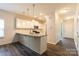 Open kitchen with stainless steel appliances, granite countertops, and white cabinets at 1415 Troon Dr, Salisbury, NC 28144