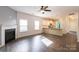 Open living space featuring wood floors, a fireplace, and an adjacent kitchen at 1415 Troon Dr, Salisbury, NC 28144