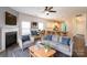 Open living space featuring wood floors, a fireplace, and an adjacent kitchen at 1415 Troon Dr, Salisbury, NC 28144