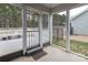 View of screened porch with concrete flooring and exit to the backyard deck and fenced in yard at 1415 Troon Dr, Salisbury, NC 28144