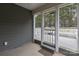 View of screened porch with concrete flooring and exit to the backyard deck and fenced in yard at 1415 Troon Dr, Salisbury, NC 28144