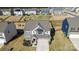 Aerial view of a two-story home with gray siding, a two-car garage, and a well-manicured lawn in a Gathering-friendly neighborhood at 154 Rooster Tail Ln, Troutman, NC 28166