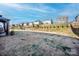 Expansive backyard with a playground and view of the surrounding neighborhood at 154 Rooster Tail Ln, Troutman, NC 28166
