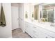 Bright bathroom with double sinks, large mirror, and tiled shower at 154 Rooster Tail Ln, Troutman, NC 28166