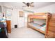 This bedroom boasts a bunk bed, a ceiling fan, and a window with white blinds at 154 Rooster Tail Ln, Troutman, NC 28166