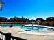 Community pool featuring a splash pad area for children, surrounded by homes and lush landscaping in a Gathering-friendly neighborhood at 154 Rooster Tail Ln, Troutman, NC 28166
