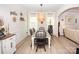 Dining room with bright light fixture over table, modern decor, and wood floors at 154 Rooster Tail Ln, Troutman, NC 28166