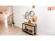 Bright entryway with wood floors, staircase and decorative console table with decorative items at 154 Rooster Tail Ln, Troutman, NC 28166