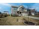 Two-story home with stone accents, landscaped yard and mature trees at 154 Rooster Tail Ln, Troutman, NC 28166
