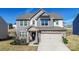 Charming two-story home with stone accents, inviting entrance, and attached two-car garage at 154 Rooster Tail Ln, Troutman, NC 28166