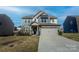 Charming two-story home featuring a stone facade, neutral siding, and a well-manicured lawn at 154 Rooster Tail Ln, Troutman, NC 28166
