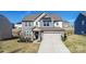 Beautifully designed two-story home with stone accents and a well-manicured front yard at 154 Rooster Tail Ln, Troutman, NC 28166