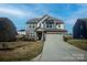 Beautiful home with a well-kept lawn, stone accents, neutral siding, and an inviting driveway at 154 Rooster Tail Ln, Troutman, NC 28166