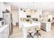 Open kitchen features an island with seating, white cabinets, and stainless steel appliances at 154 Rooster Tail Ln, Troutman, NC 28166