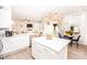 Bright and airy kitchen with white cabinetry, stainless appliances, and adjacent dining area at 154 Rooster Tail Ln, Troutman, NC 28166