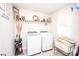 Well-lit laundry room with modern washer, dryer, shelving, and decor at 154 Rooster Tail Ln, Troutman, NC 28166