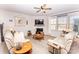 Cozy living room with comfortable seating, a fireplace, and a ceiling fan, perfect for relaxing and entertaining at 154 Rooster Tail Ln, Troutman, NC 28166