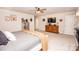 Bright main bedroom with a mounted television, hardwood dresser, and white trim at 154 Rooster Tail Ln, Troutman, NC 28166