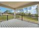 Enjoy the outdoors on this covered back porch with black metal railing and serene view at 163 Windy Dell Dr, Tega Cay, SC 29708