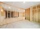 Unfinished basement with stairs, concrete floor, and framing for future rooms at 163 Windy Dell Dr, Tega Cay, SC 29708
