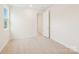 Bright bedroom features a neutral carpet and paint color with a view outside at 163 Windy Dell Dr, Tega Cay, SC 29708