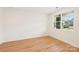 Bright bedroom featuring hardwood floors, a large window, and neutral paint at 163 Windy Dell Dr, Tega Cay, SC 29708