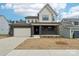 New construction two-story home featuring a brick veneer, attached garage, and covered front porch at 163 Windy Dell Dr, Tega Cay, SC 29708